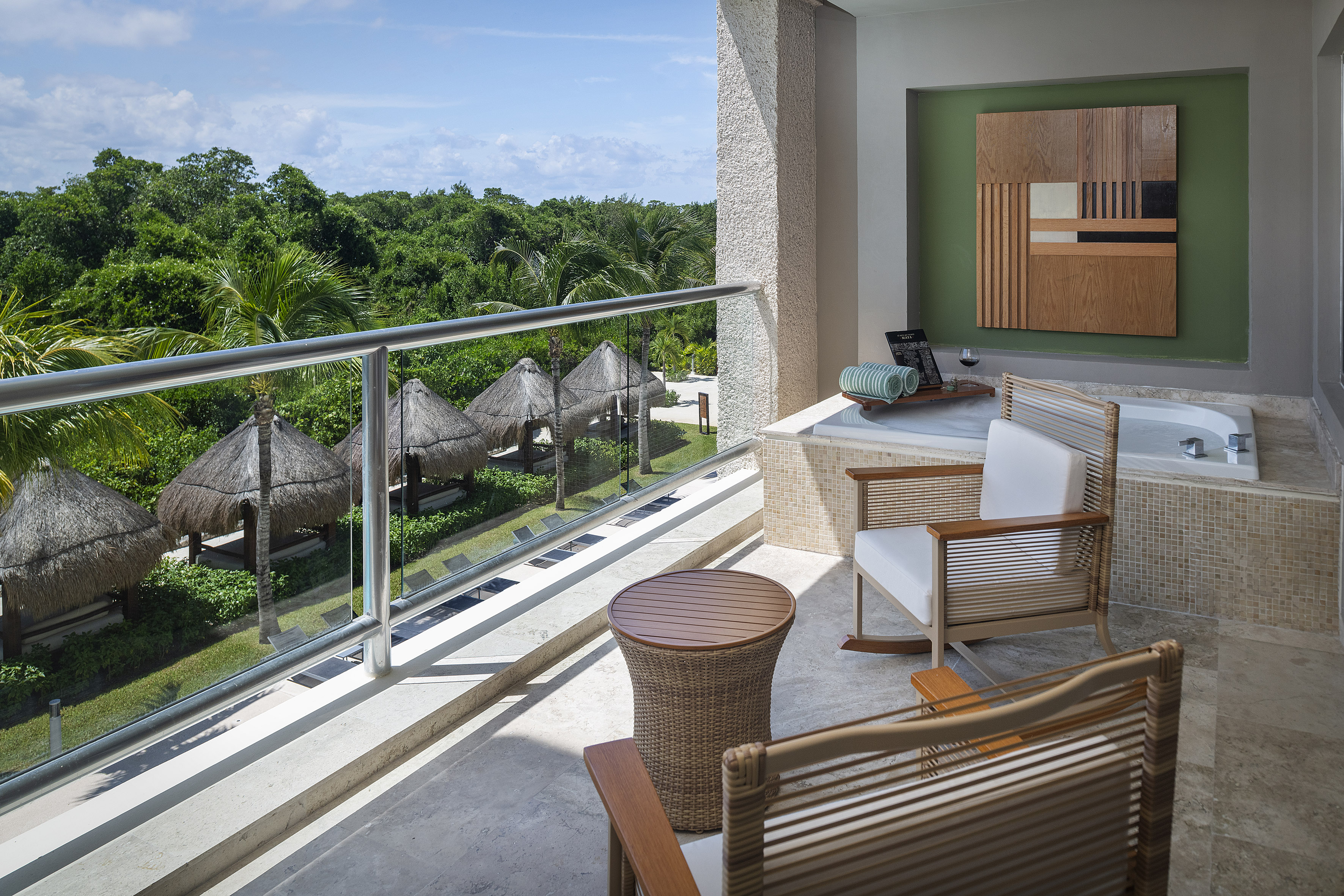 a balcony with chairs and a table.
