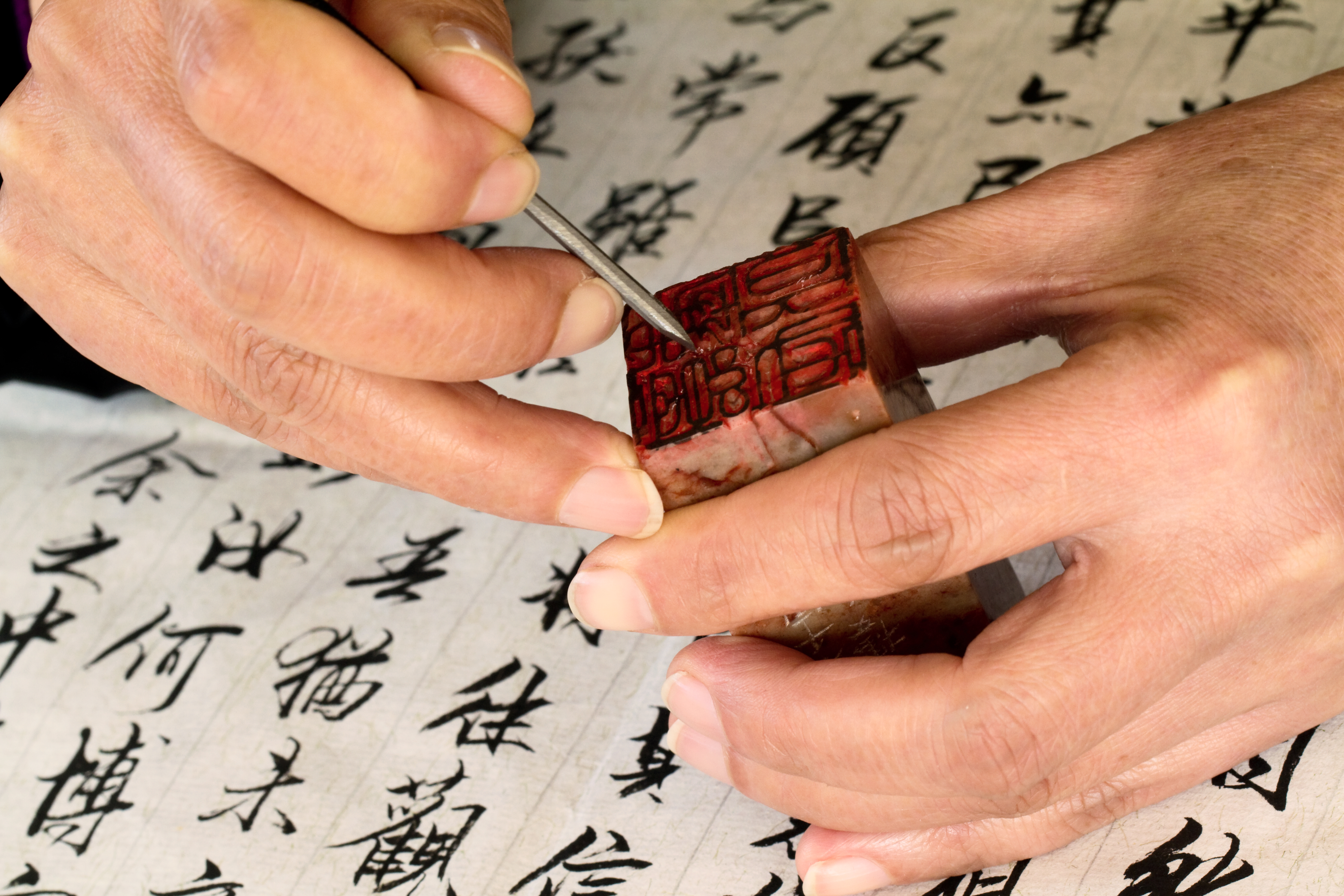 a person using a stamp to seal something