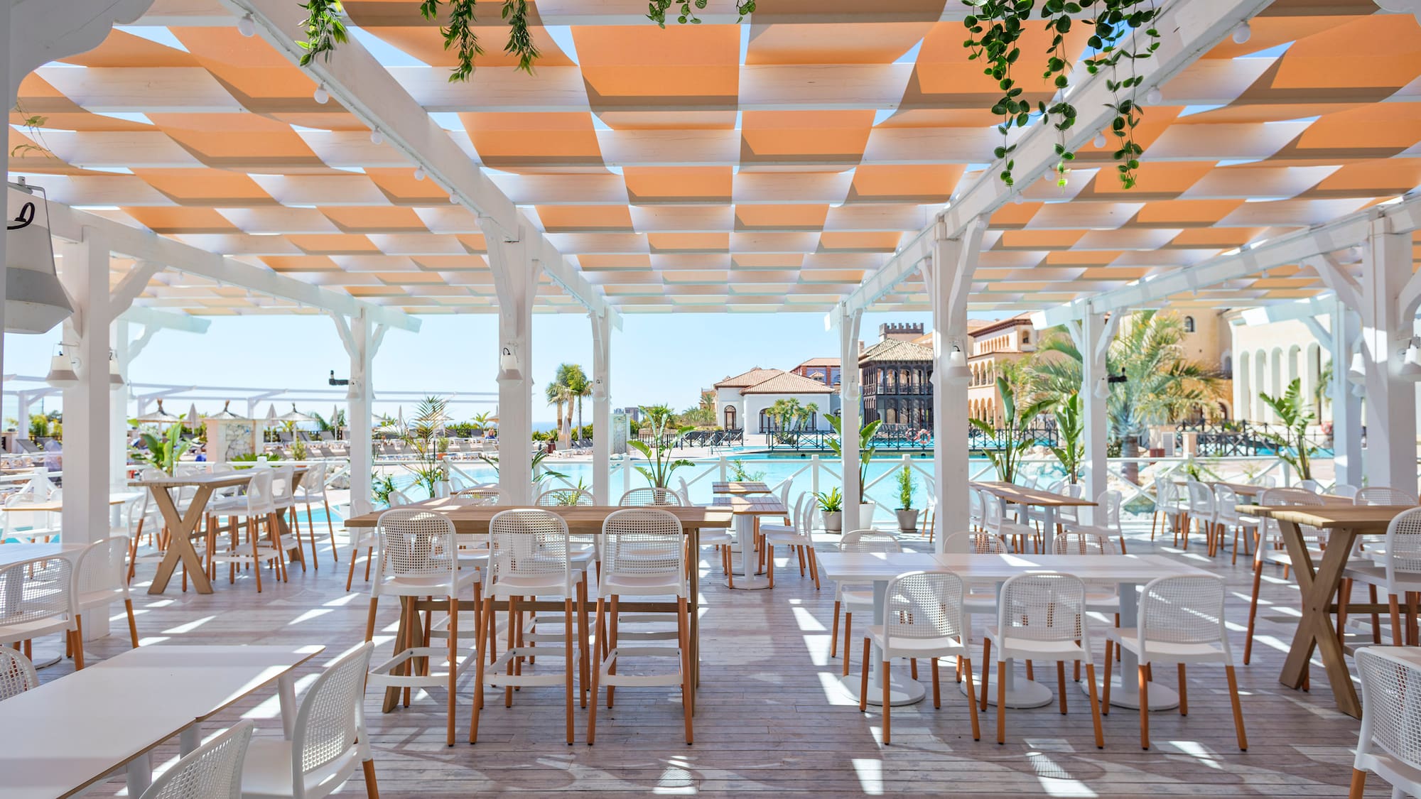 a white patio with tables and chairs