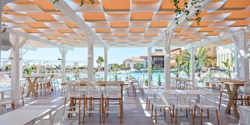 a white patio with tables and chairs
