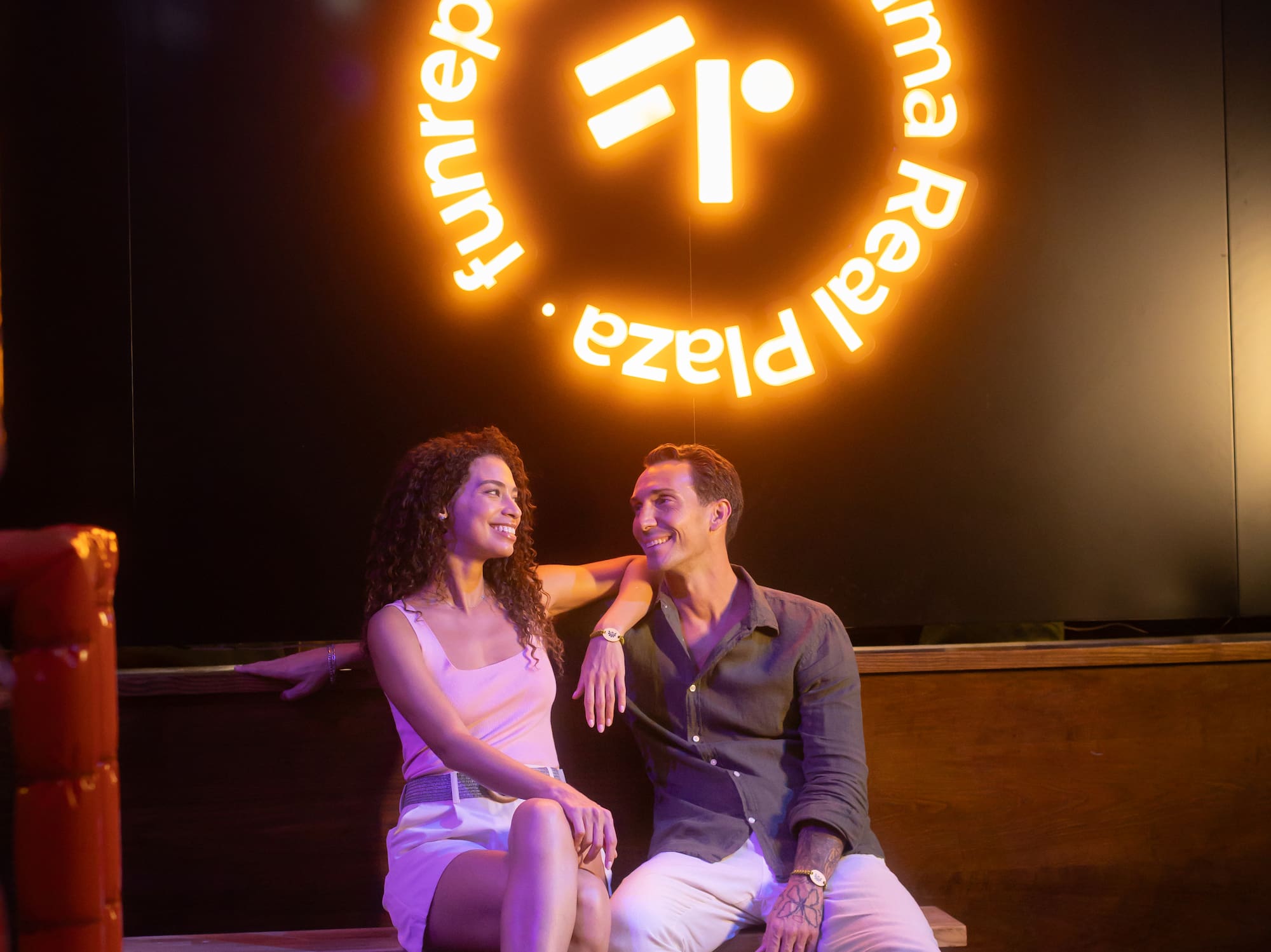 a man and woman sitting on a bench