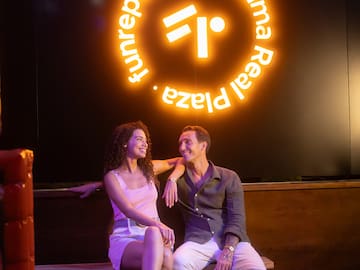 a man and woman sitting on a bench