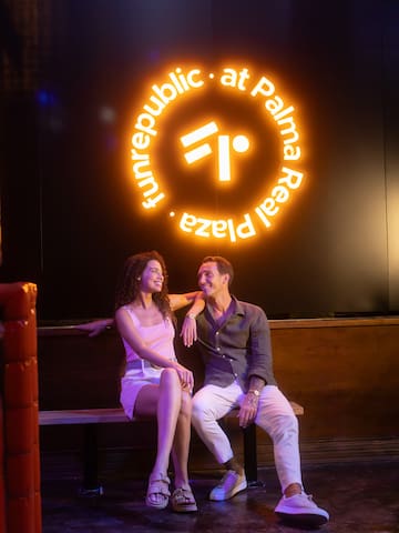 a man and woman sitting on a bench