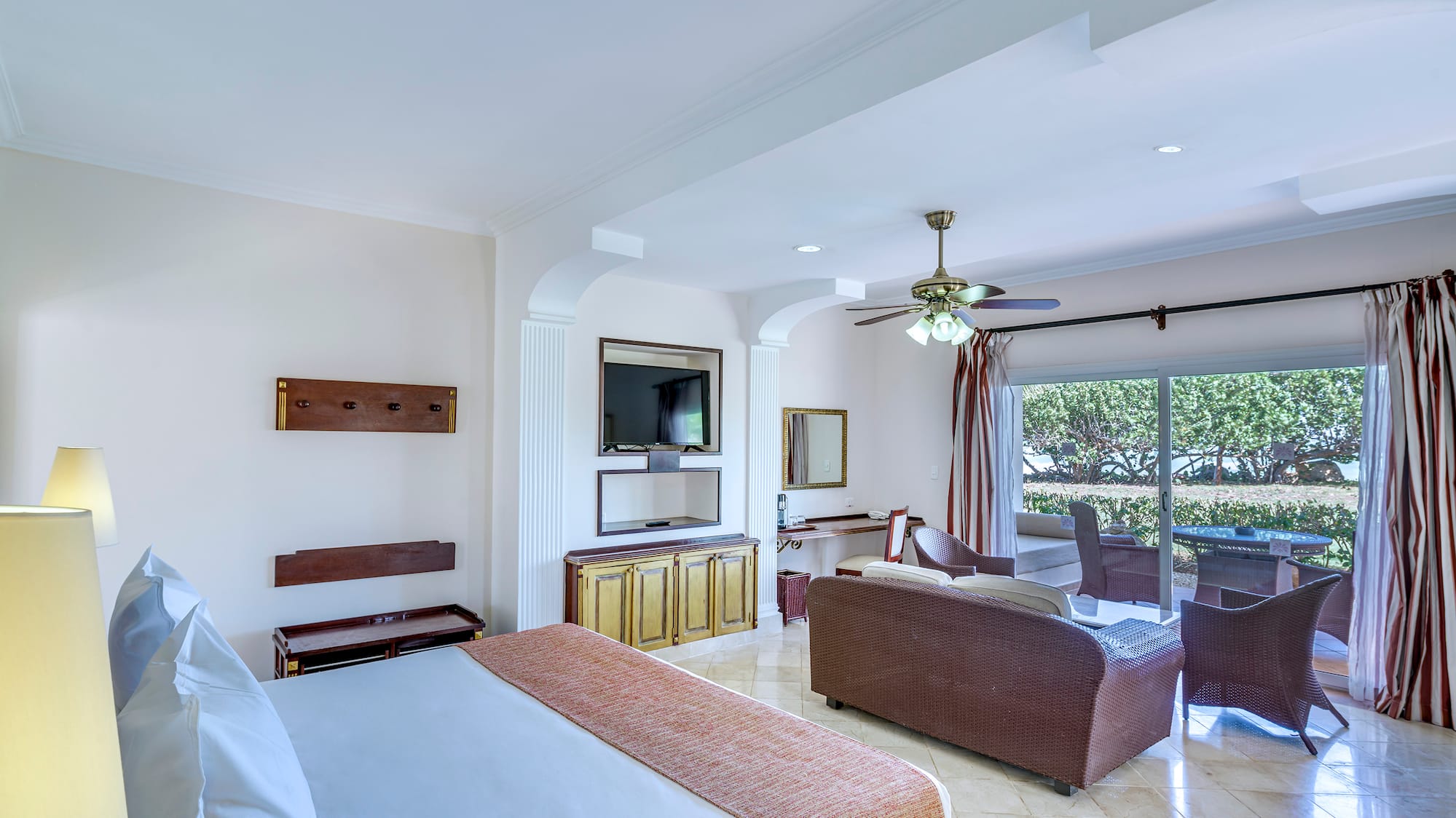 a room with a bed and a television