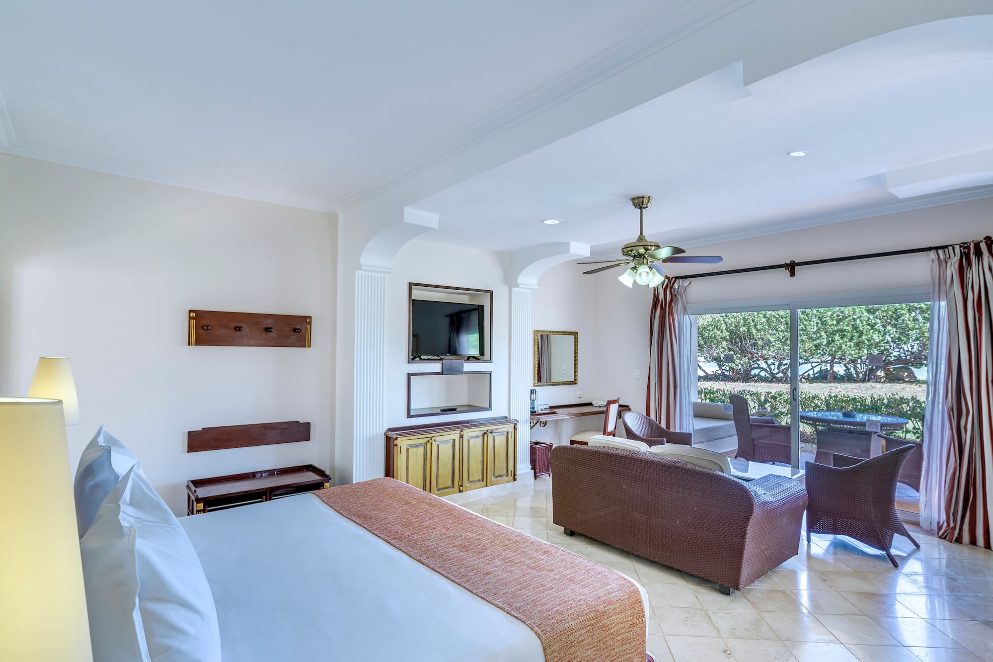 a room with a bed and a television