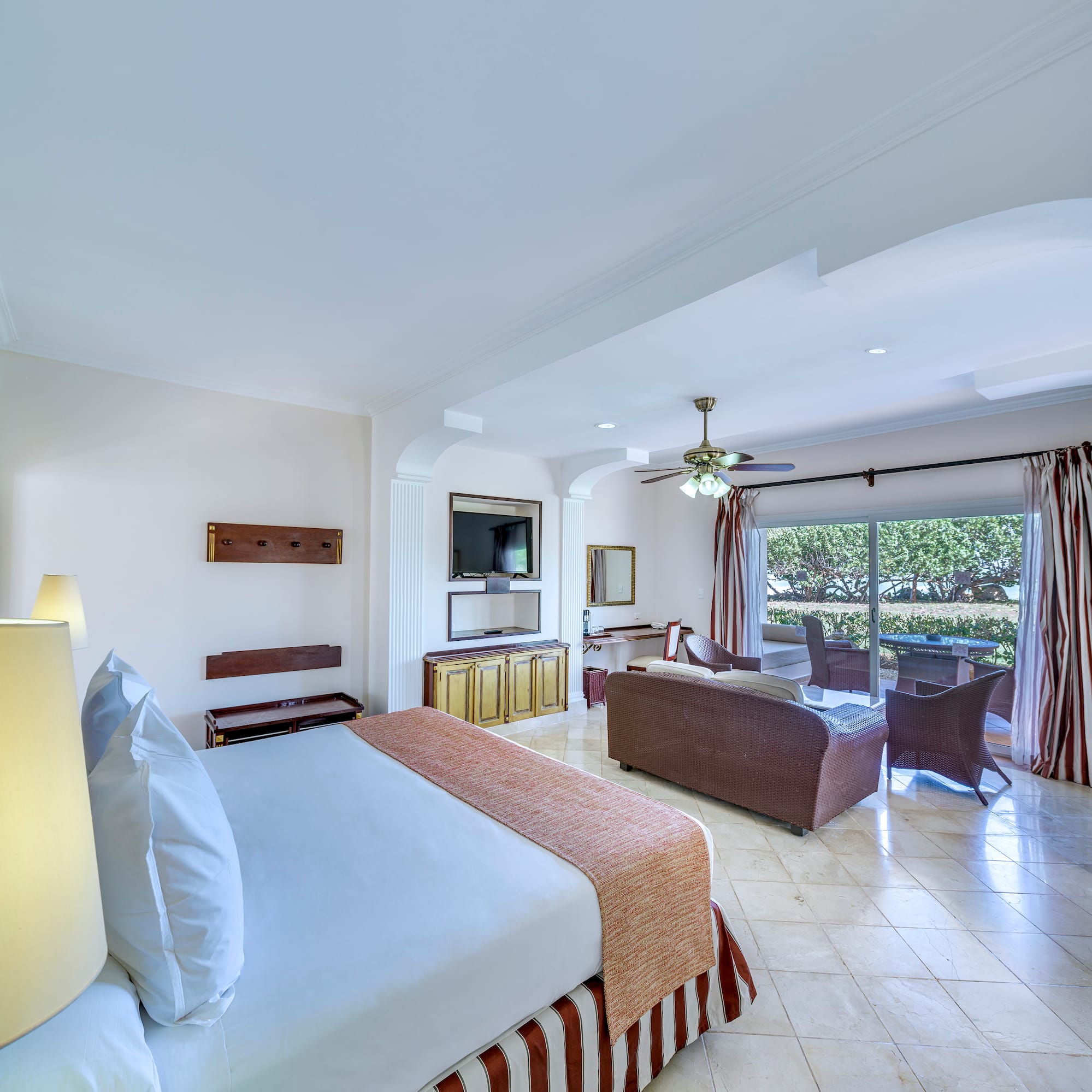 a room with a bed and a television