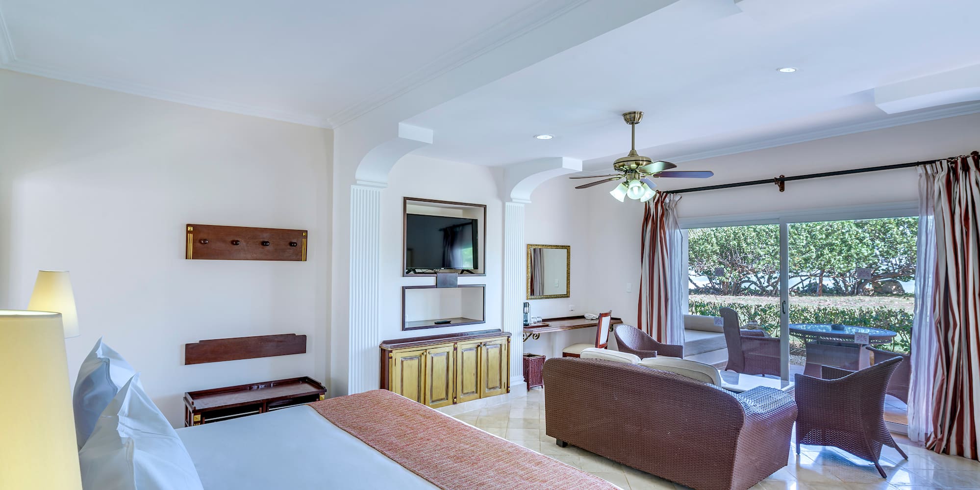 a room with a bed and a television