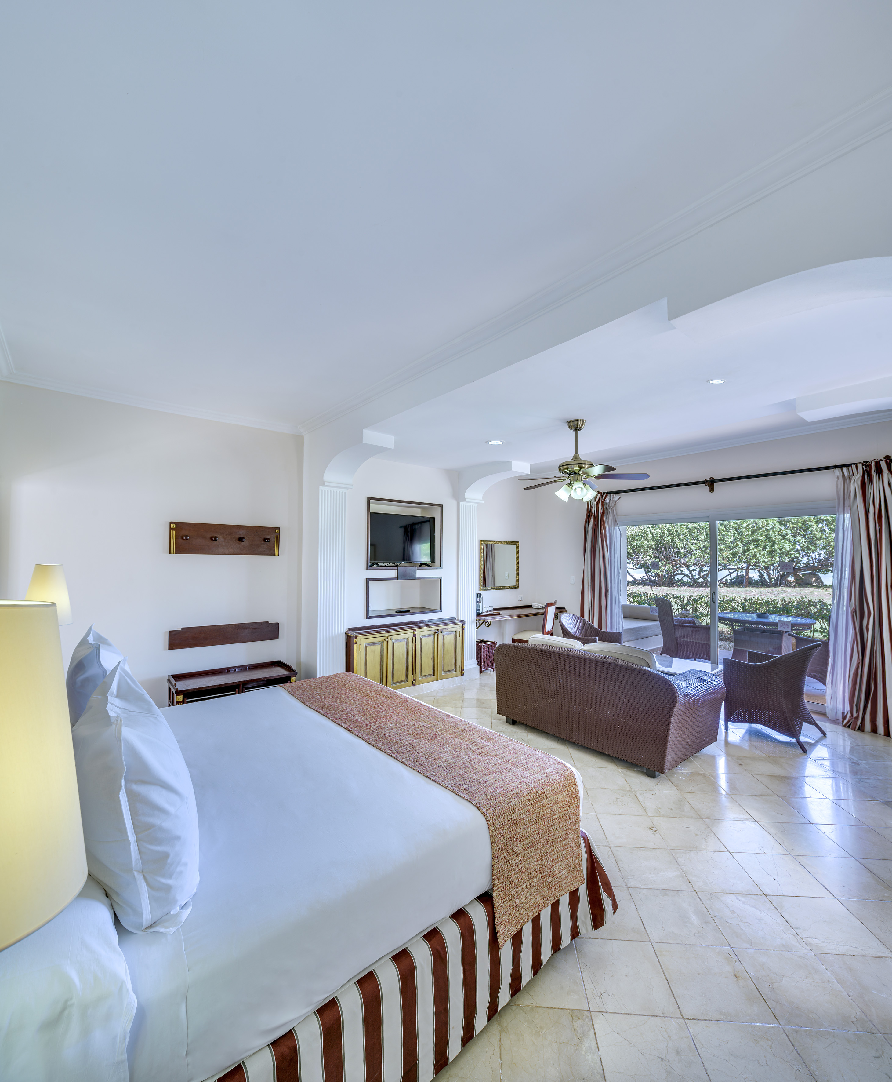 a room with a bed and a television