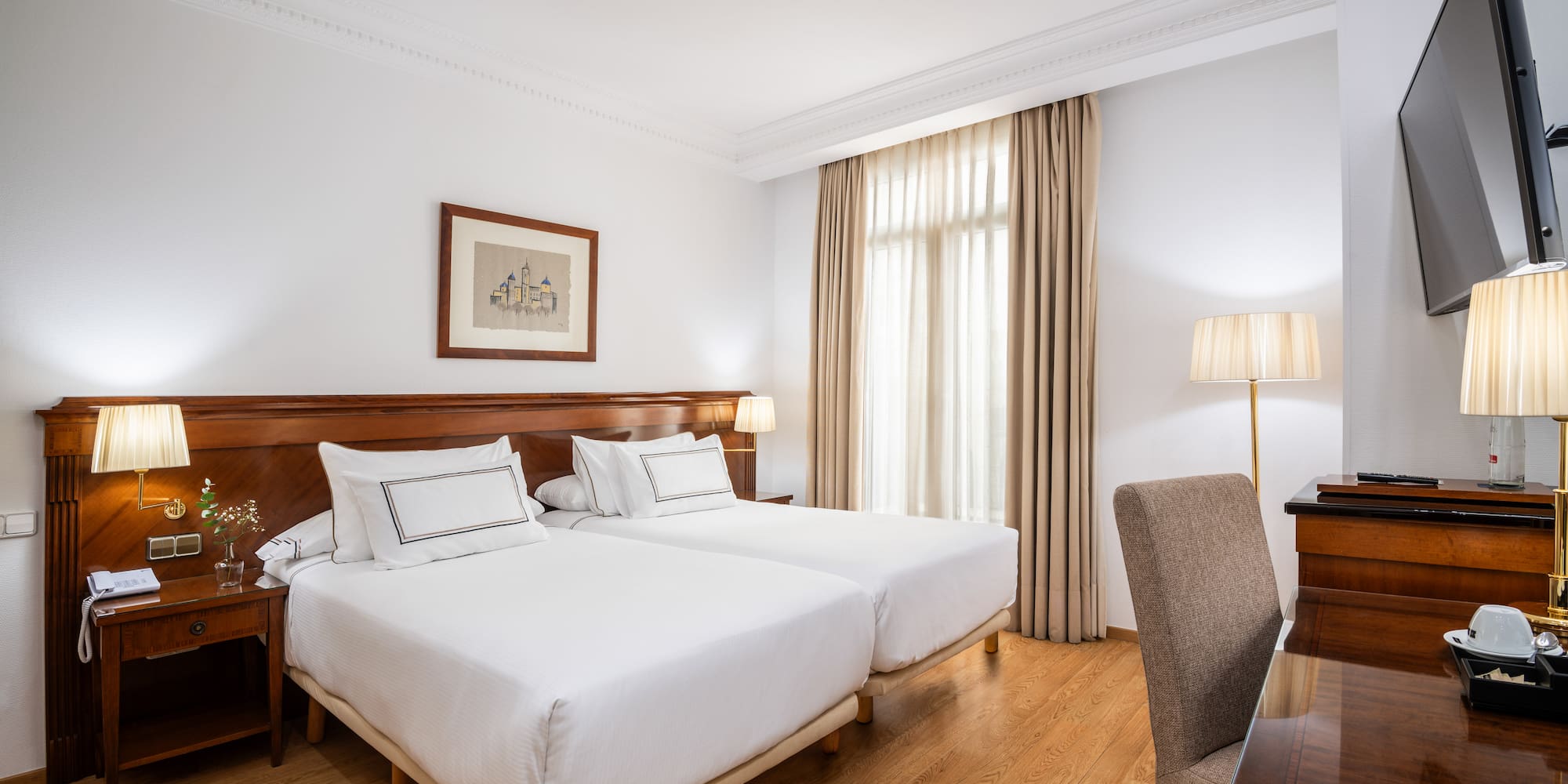 a room with two beds and a desk