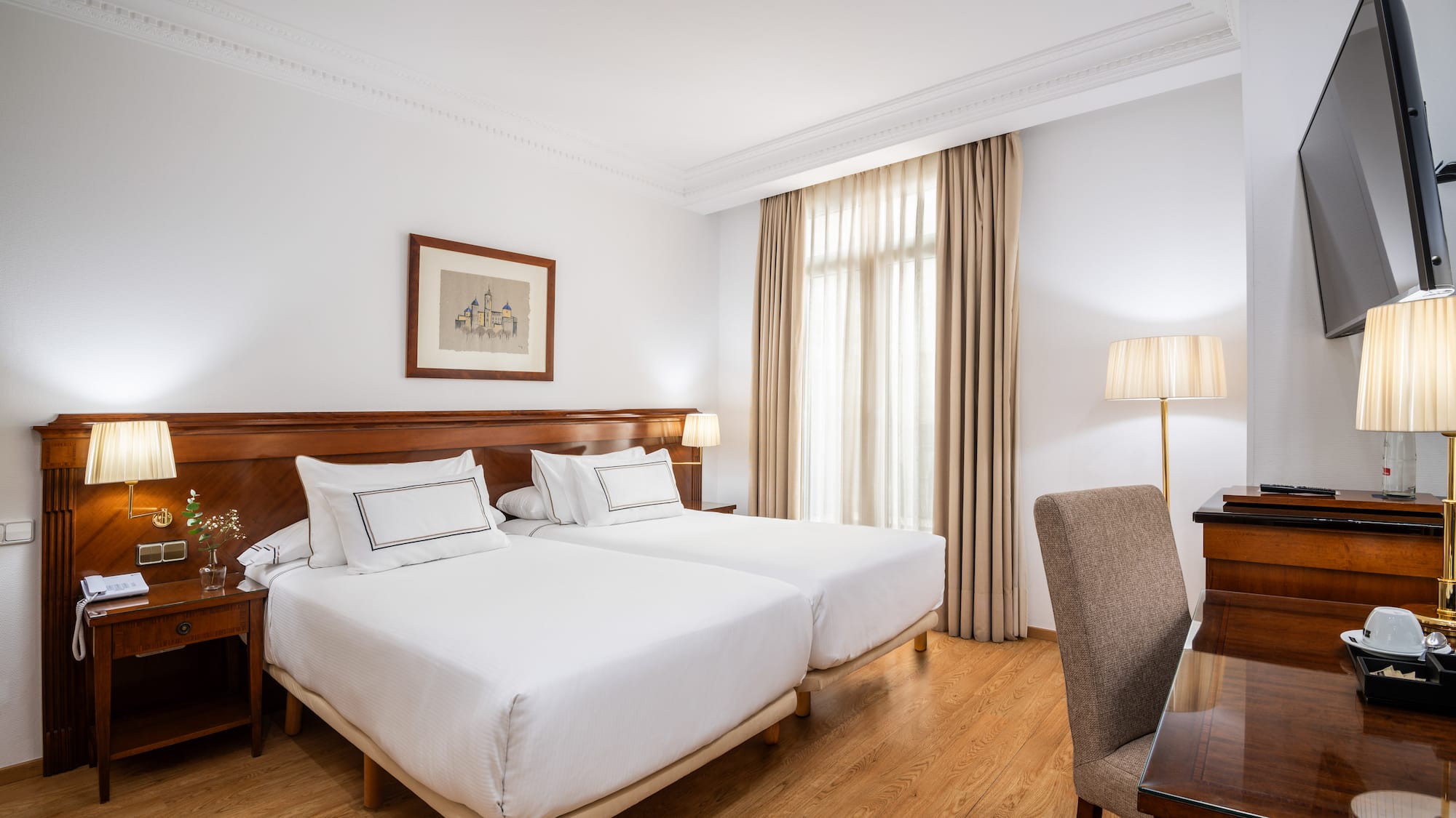 a room with two beds and a desk