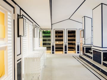a white and blue room with stairs and white walls