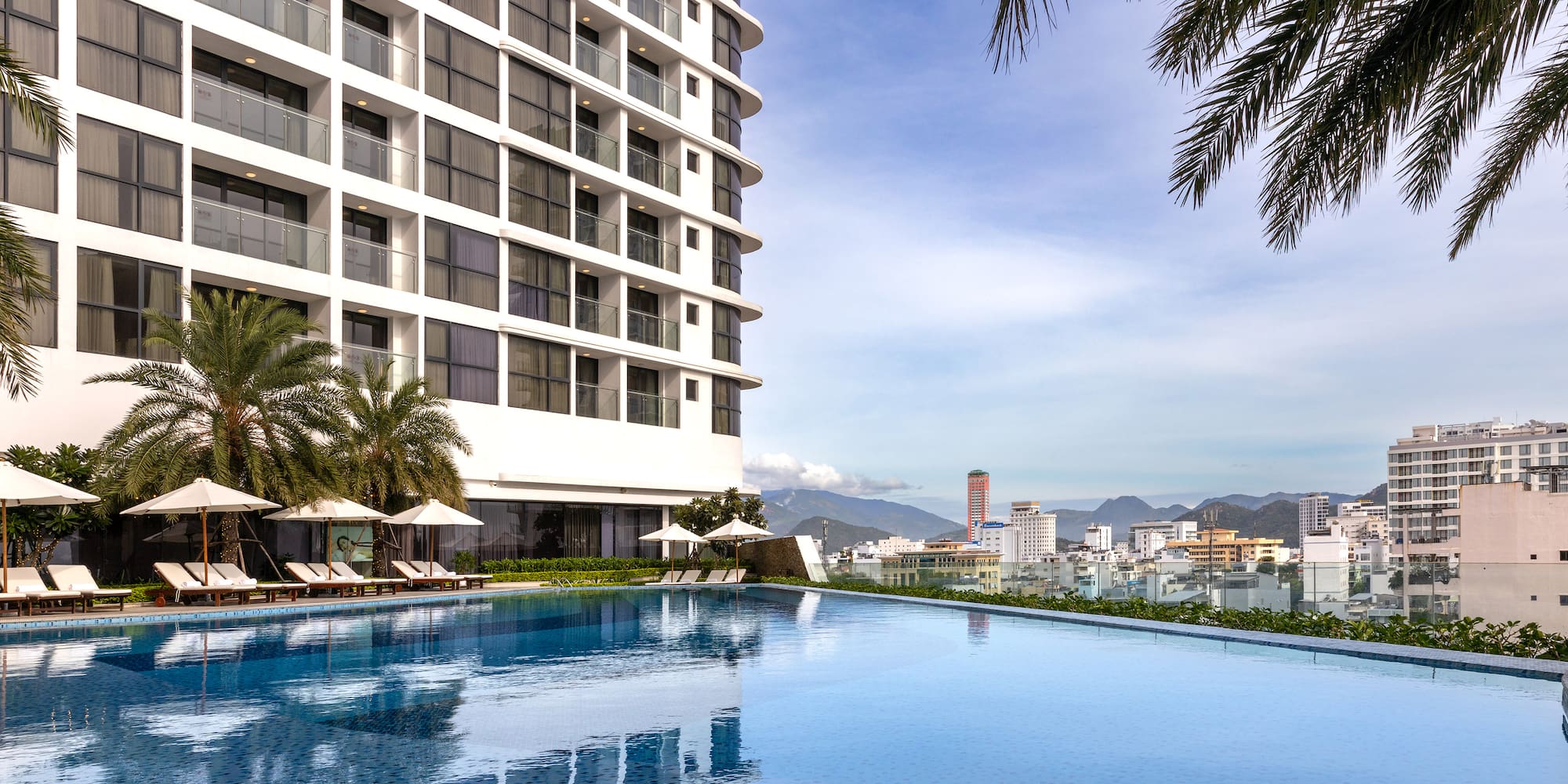 a pool with a large building in the background