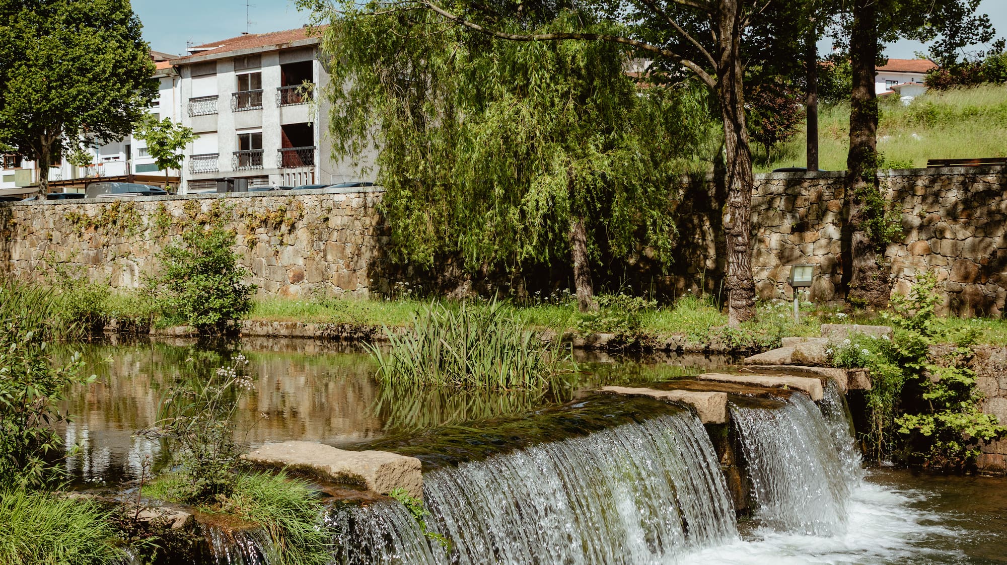 a waterfall over a river
