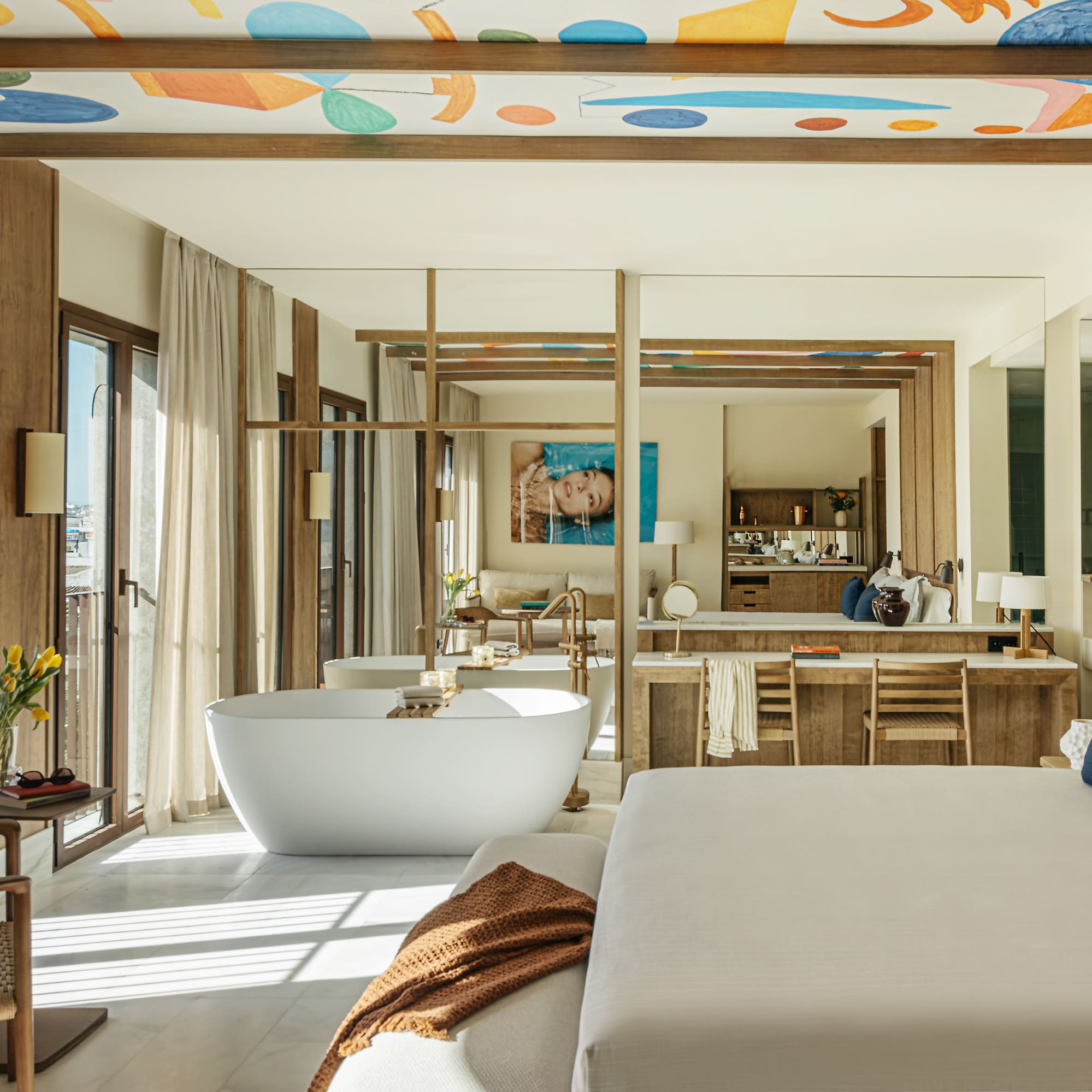 a large room with a large bed and a bathtub