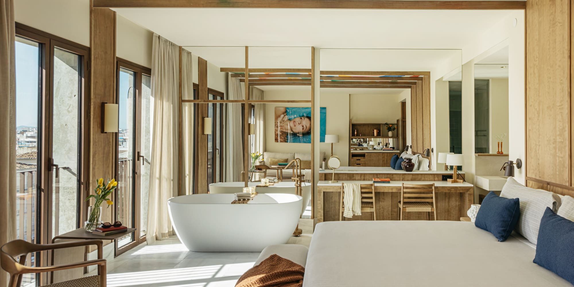 a large room with a large bed and a bathtub