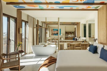 a large room with a large bed and a bathtub