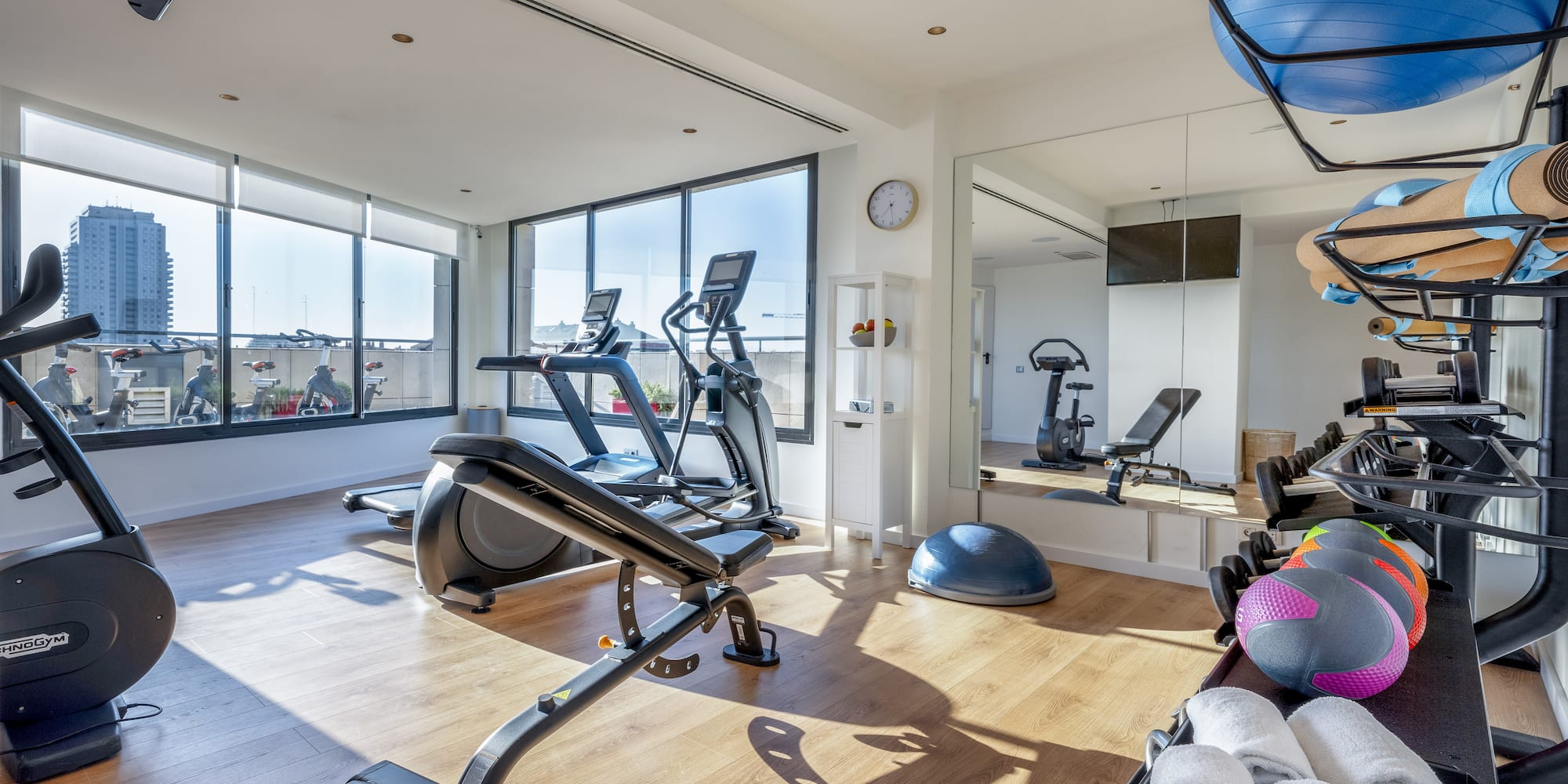 a room with exercise equipment and a mirror