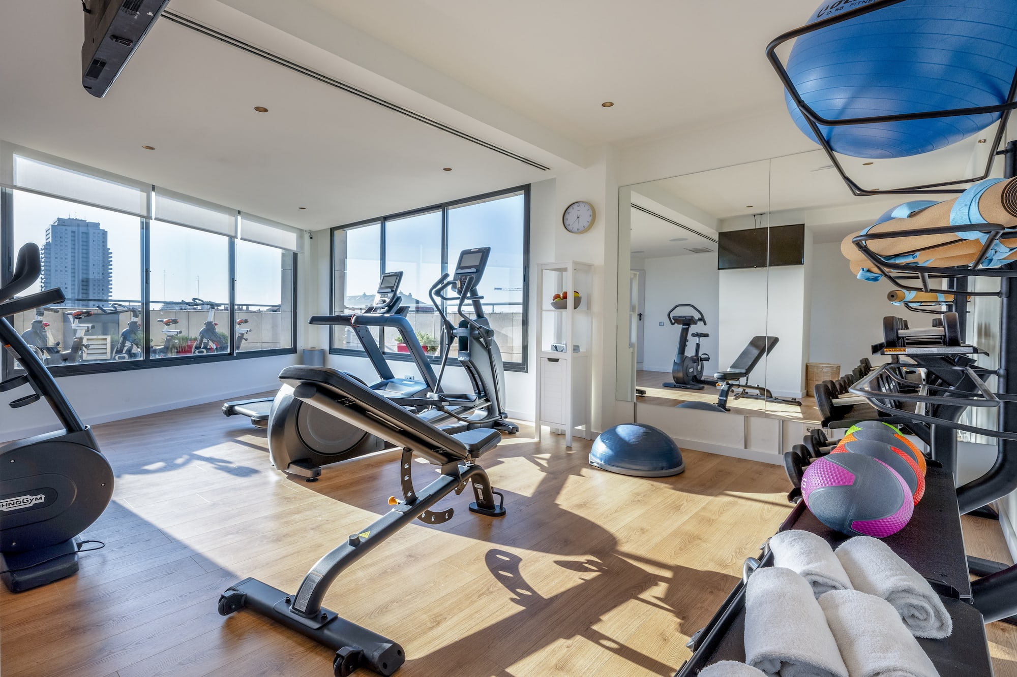a room with exercise equipment and a mirror