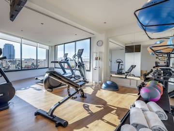 a room with exercise equipment and a mirror