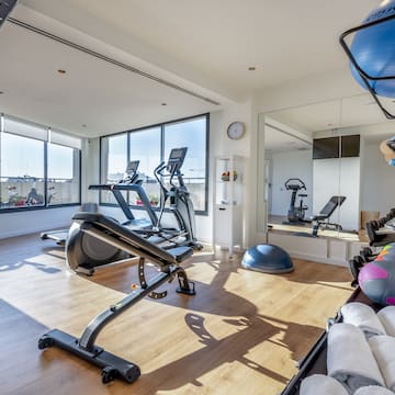 a room with exercise equipment and a mirror