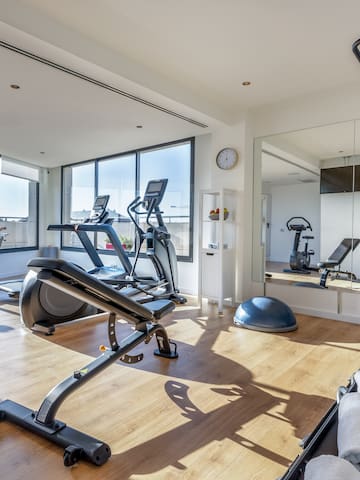 a room with exercise equipment and a mirror