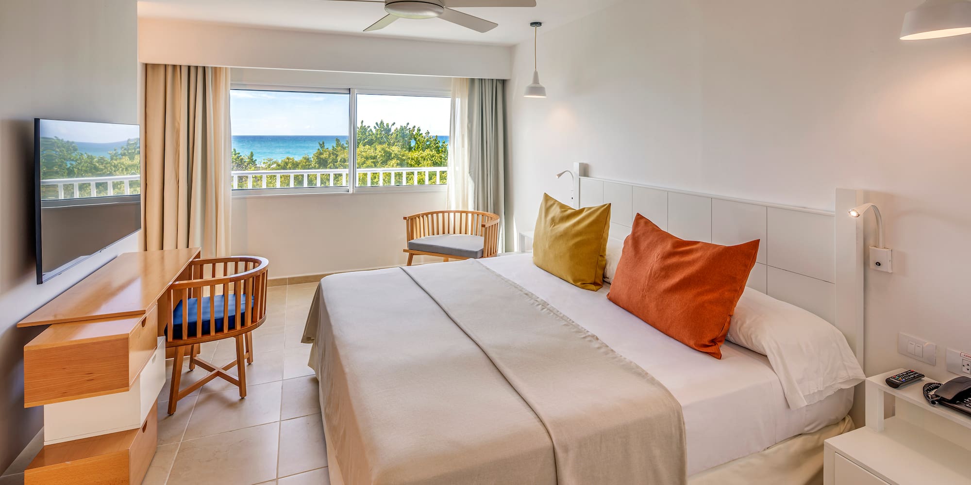 a room with a bed and a desk and chair