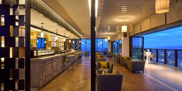 a room with a bar and chairs