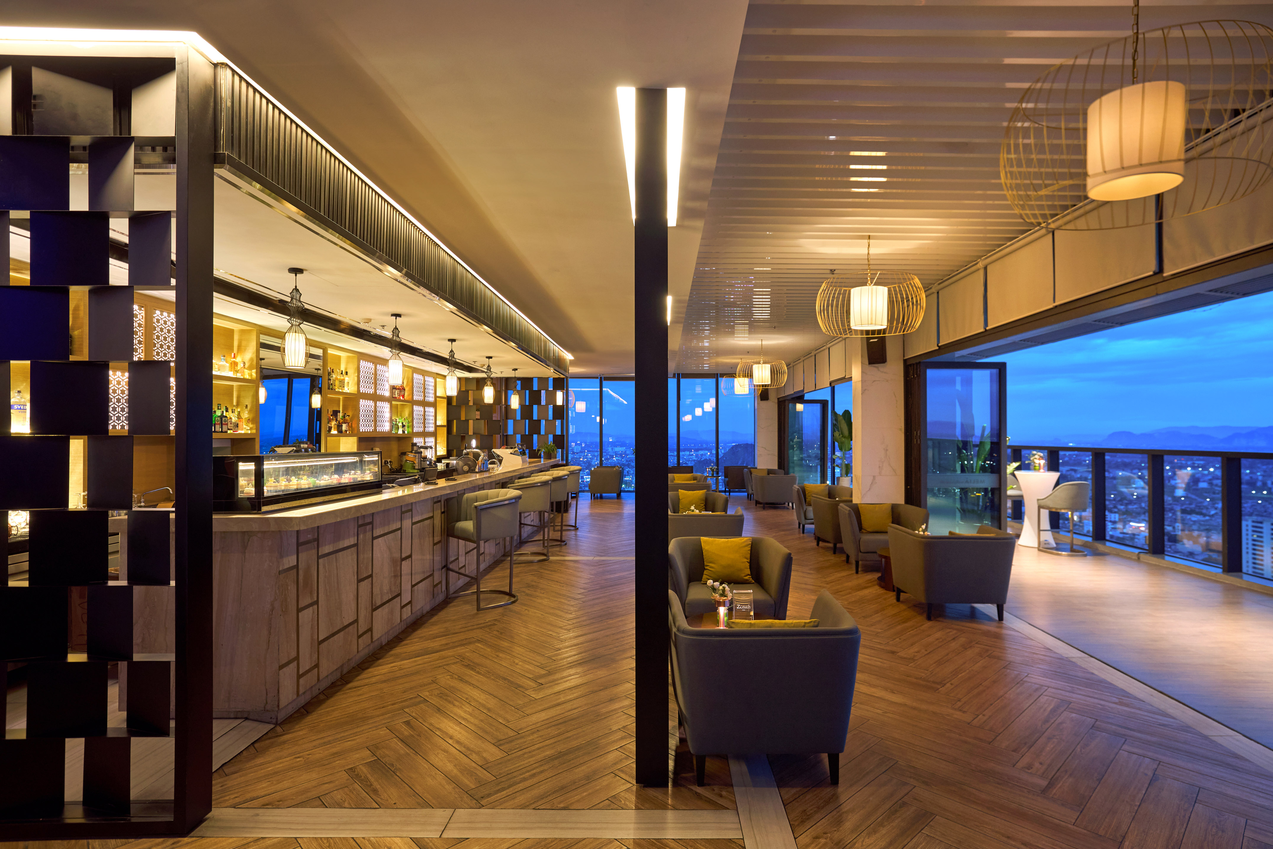 Upscale rooftop bar with evening city view, modern lounge interior.