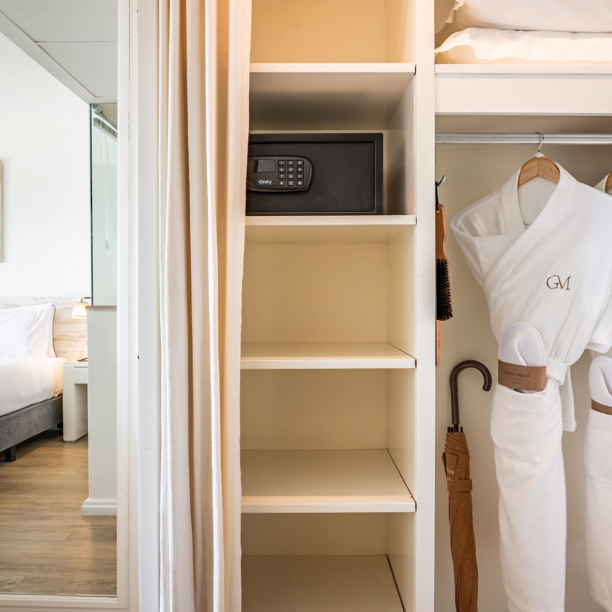 a white robe on a swinger in a closet