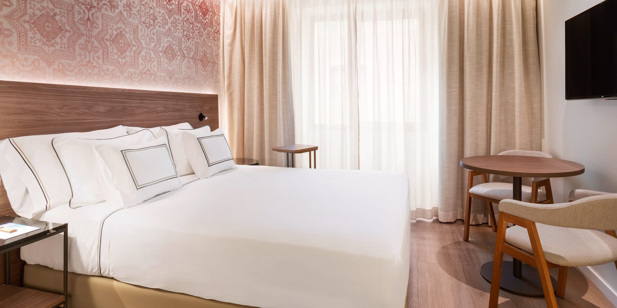 a bed with a table and chairs in a room