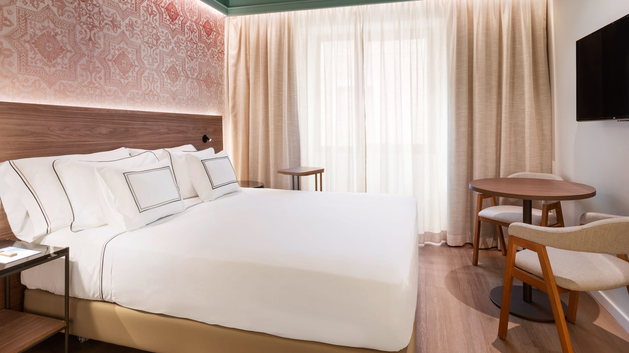 a bed with a table and chairs in a room