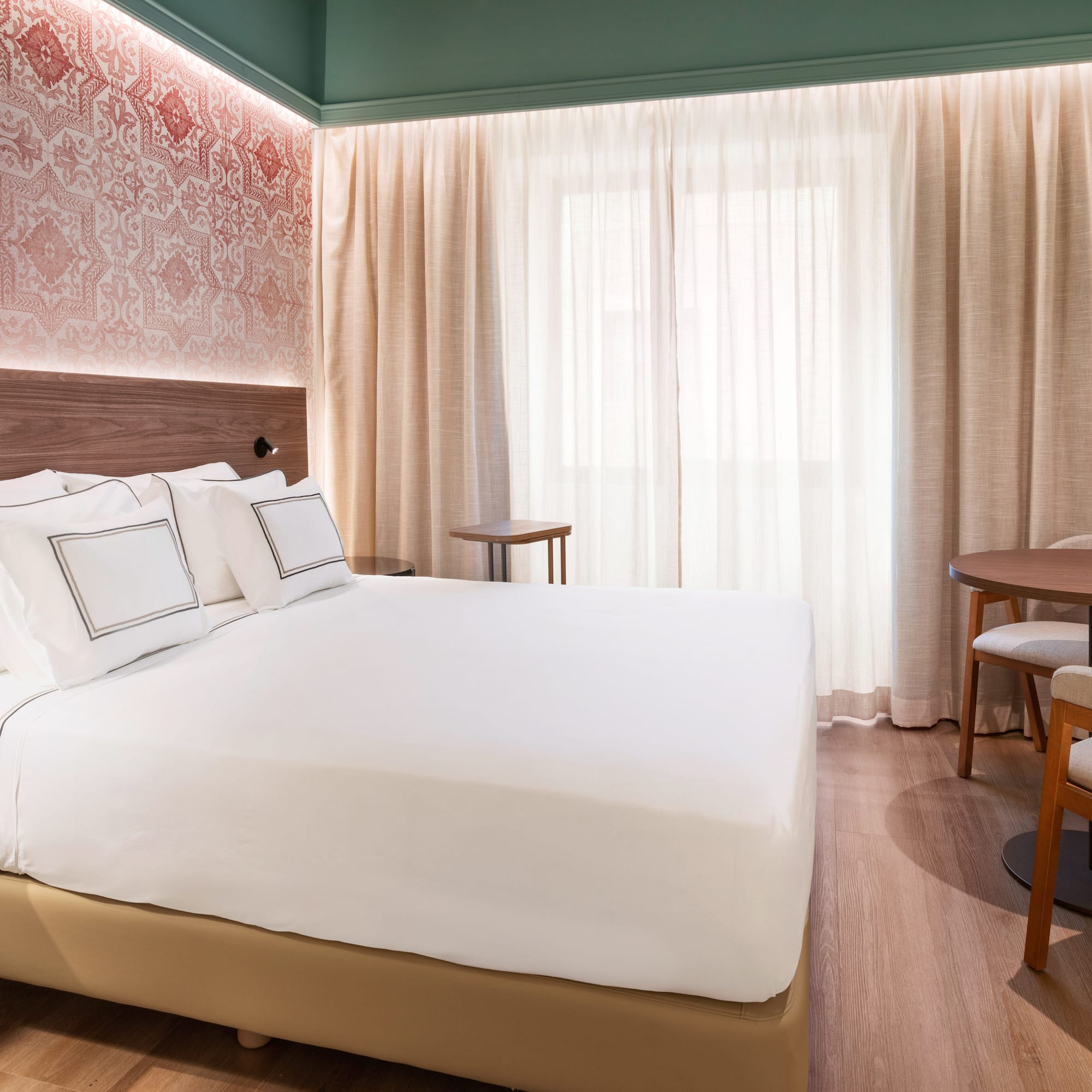 a bed with a table and chairs in a room