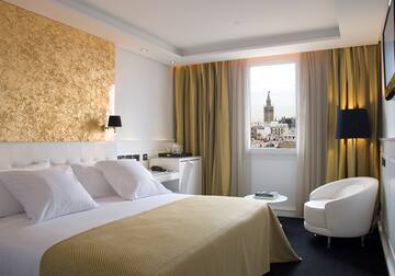 a bedroom with a bed and a chair