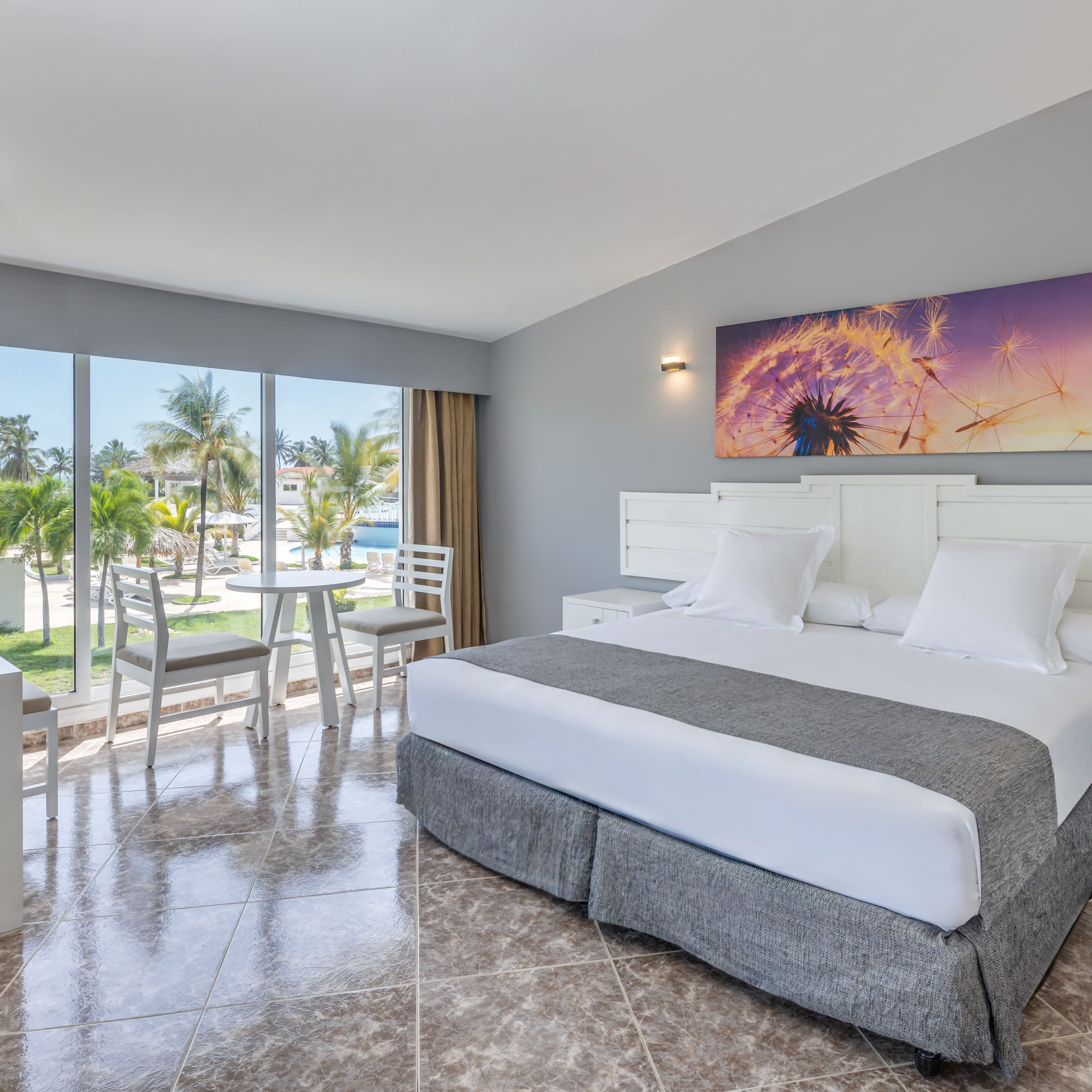 a room with a bed and chairs and a table