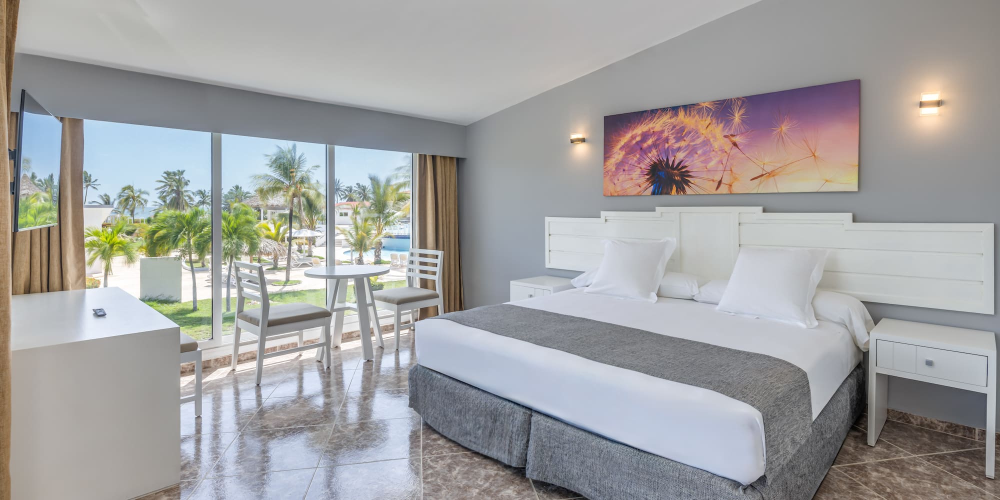 a room with a bed and chairs and a table