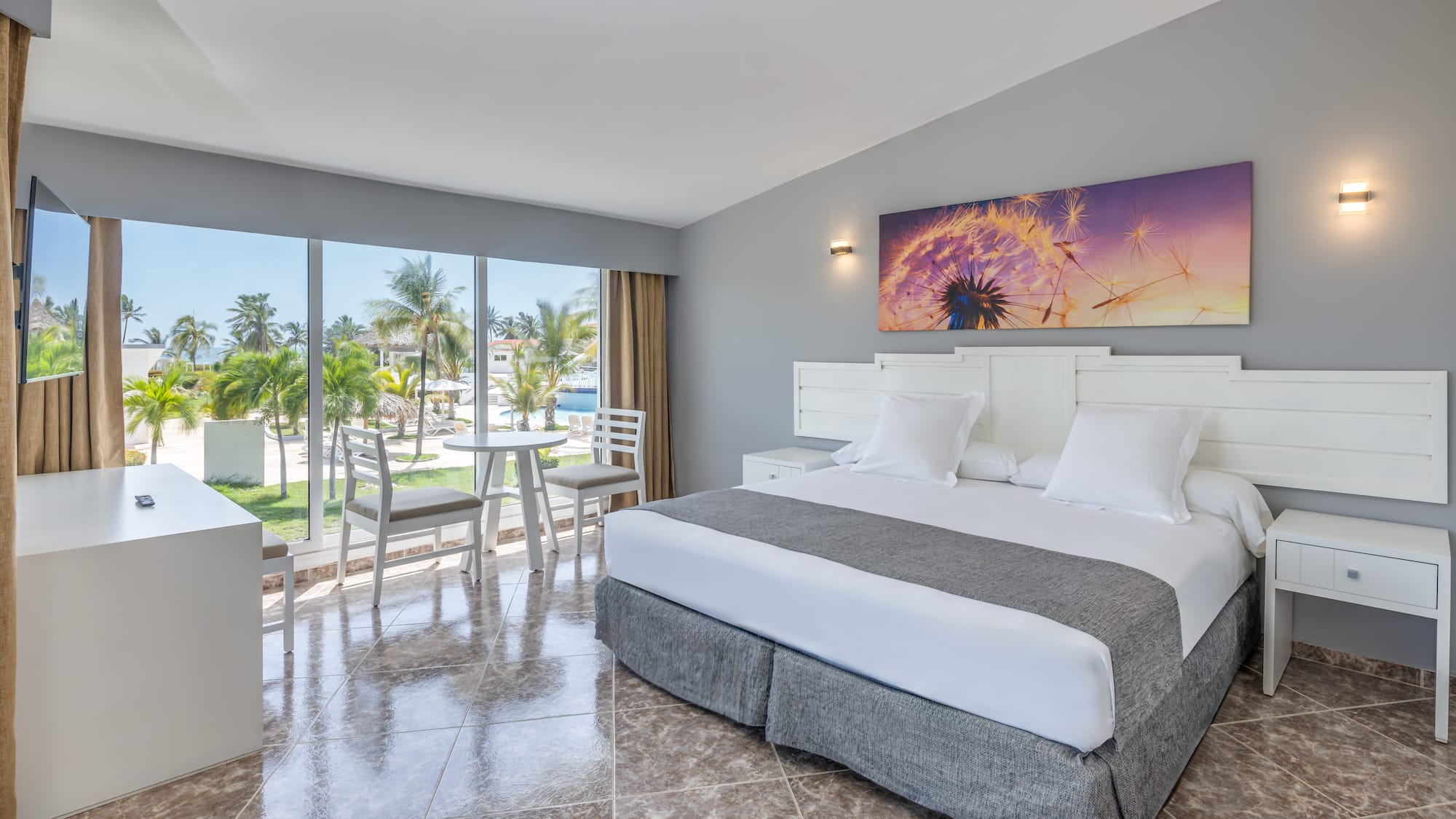 a room with a bed and chairs and a table