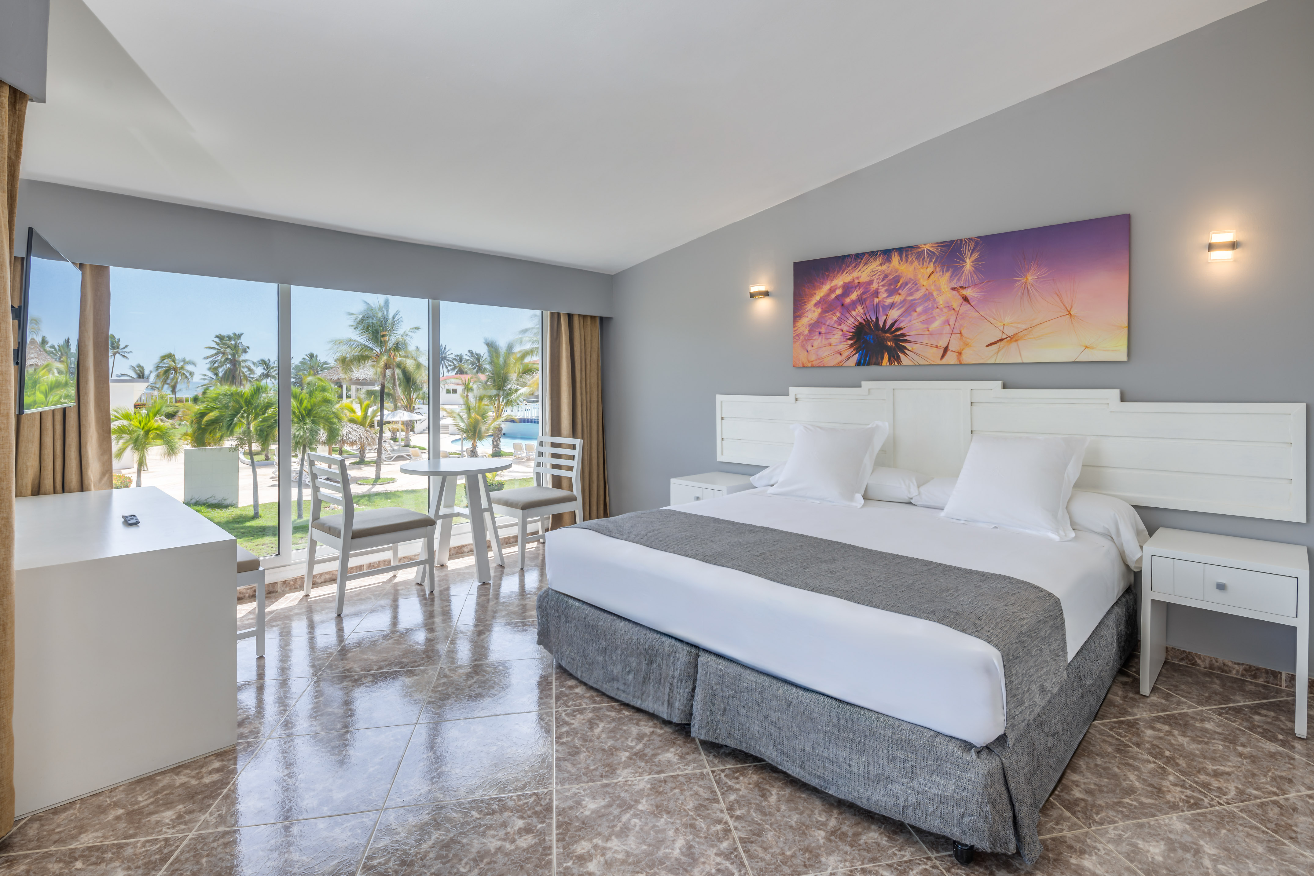 a room with a bed and chairs and a table