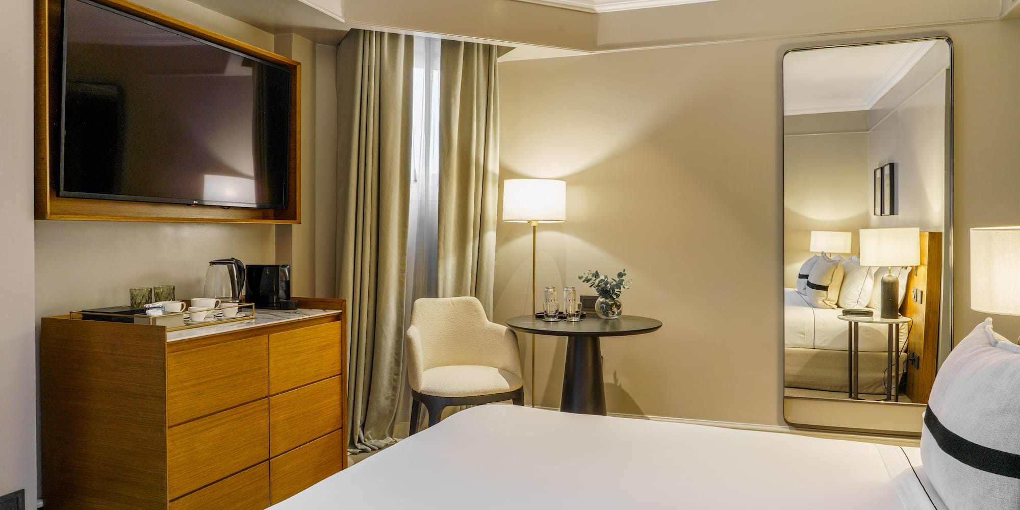 a room with a large mirror and a bed