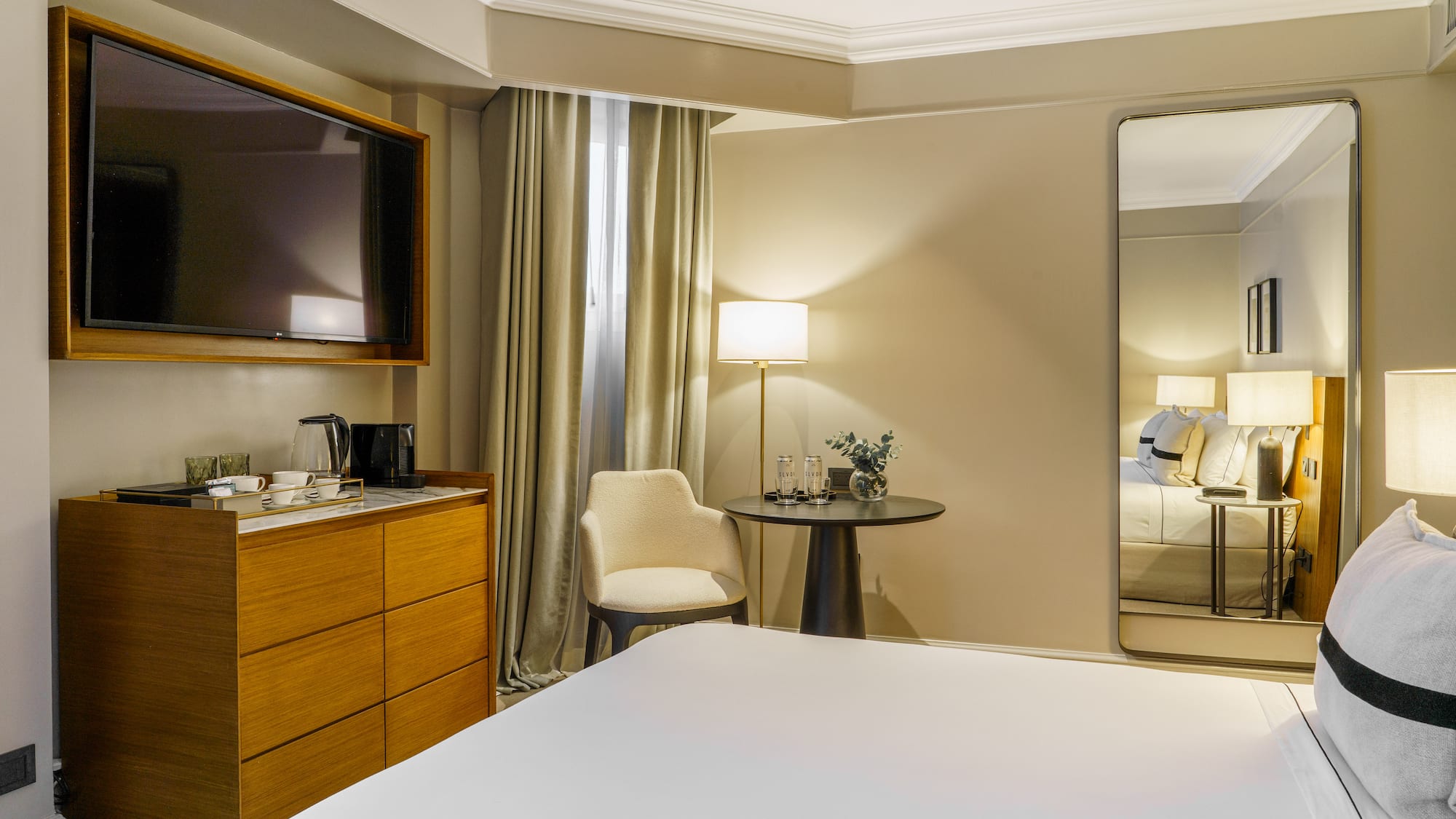 a room with a large mirror and a bed