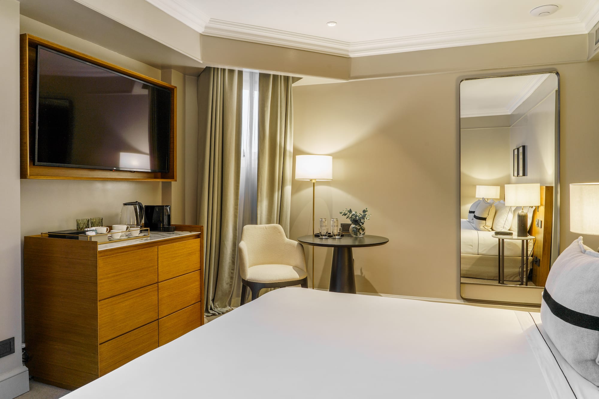 a room with a large mirror and a bed