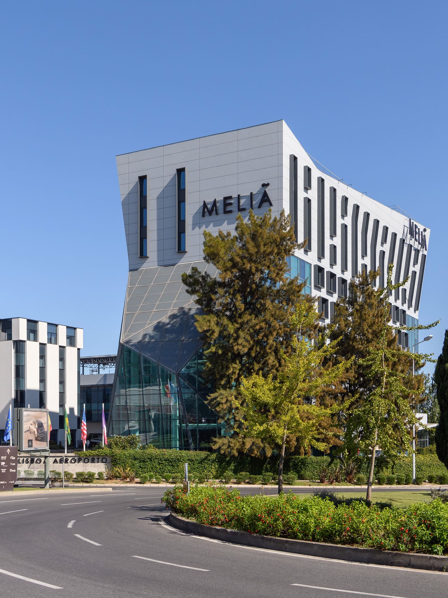 a building with trees and a road