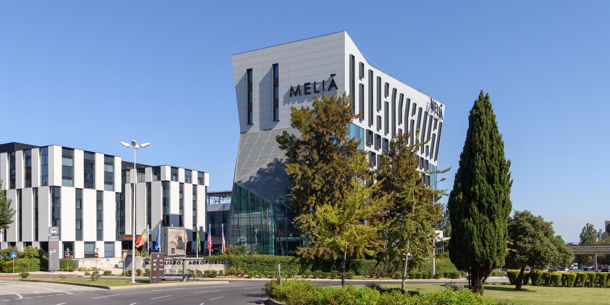 a building with trees and a road