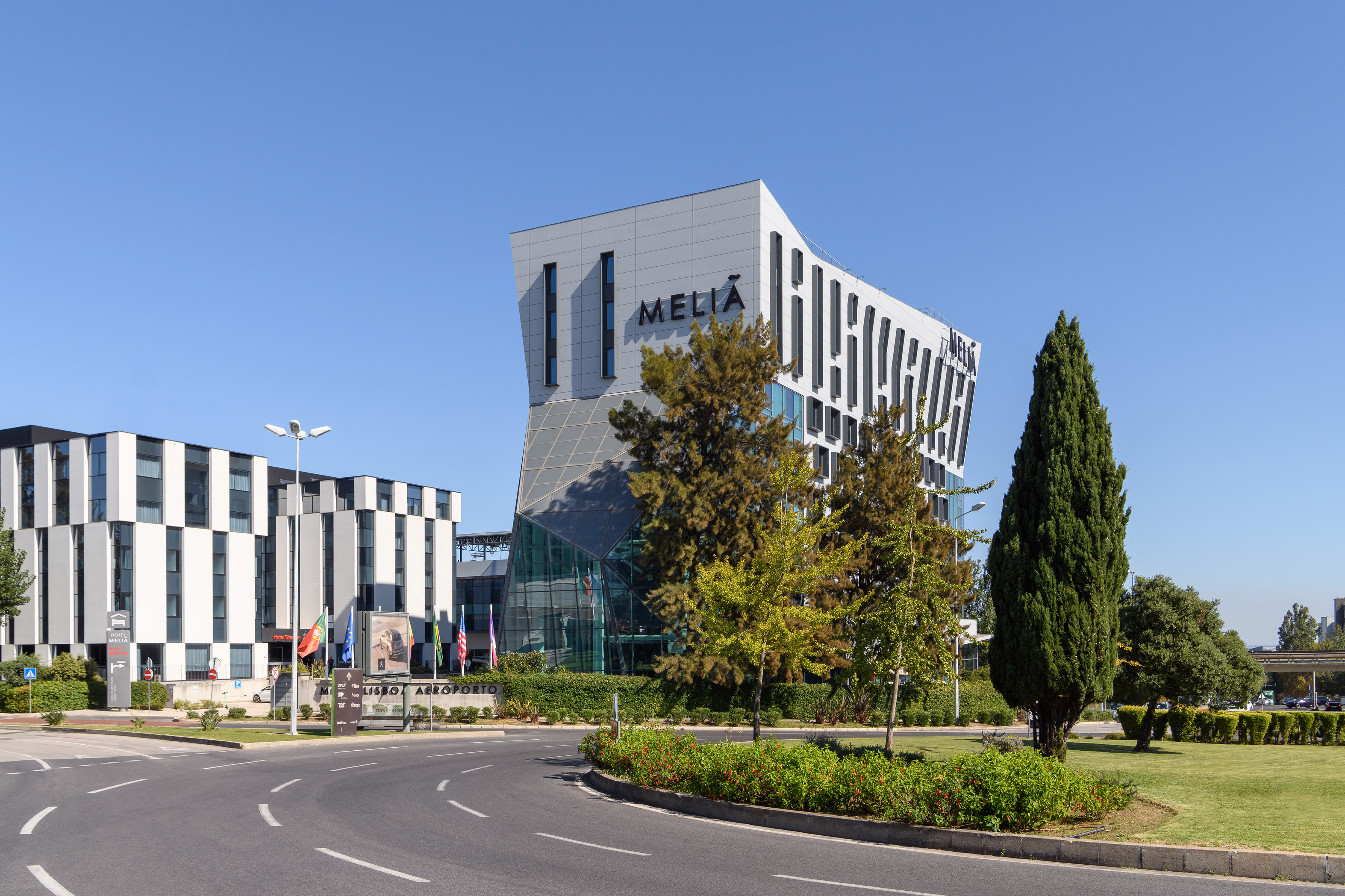 Modern Meliá Lisbon Airport Hotel, distinctive architecture, roads.