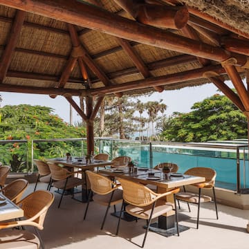 a restaurant with a thatched roof