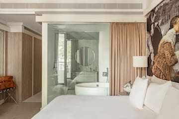 a bed with a tub and a shower