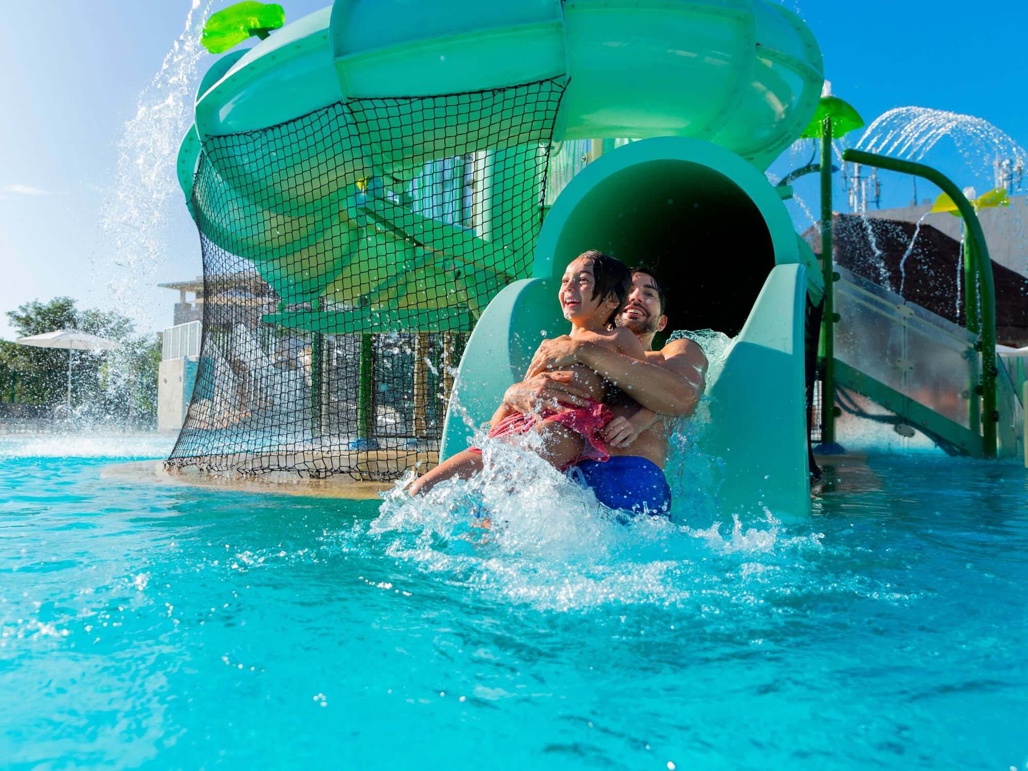 a man and woman on a water slide