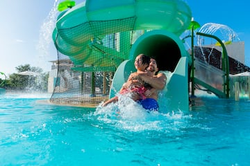 a man and woman on a water slide