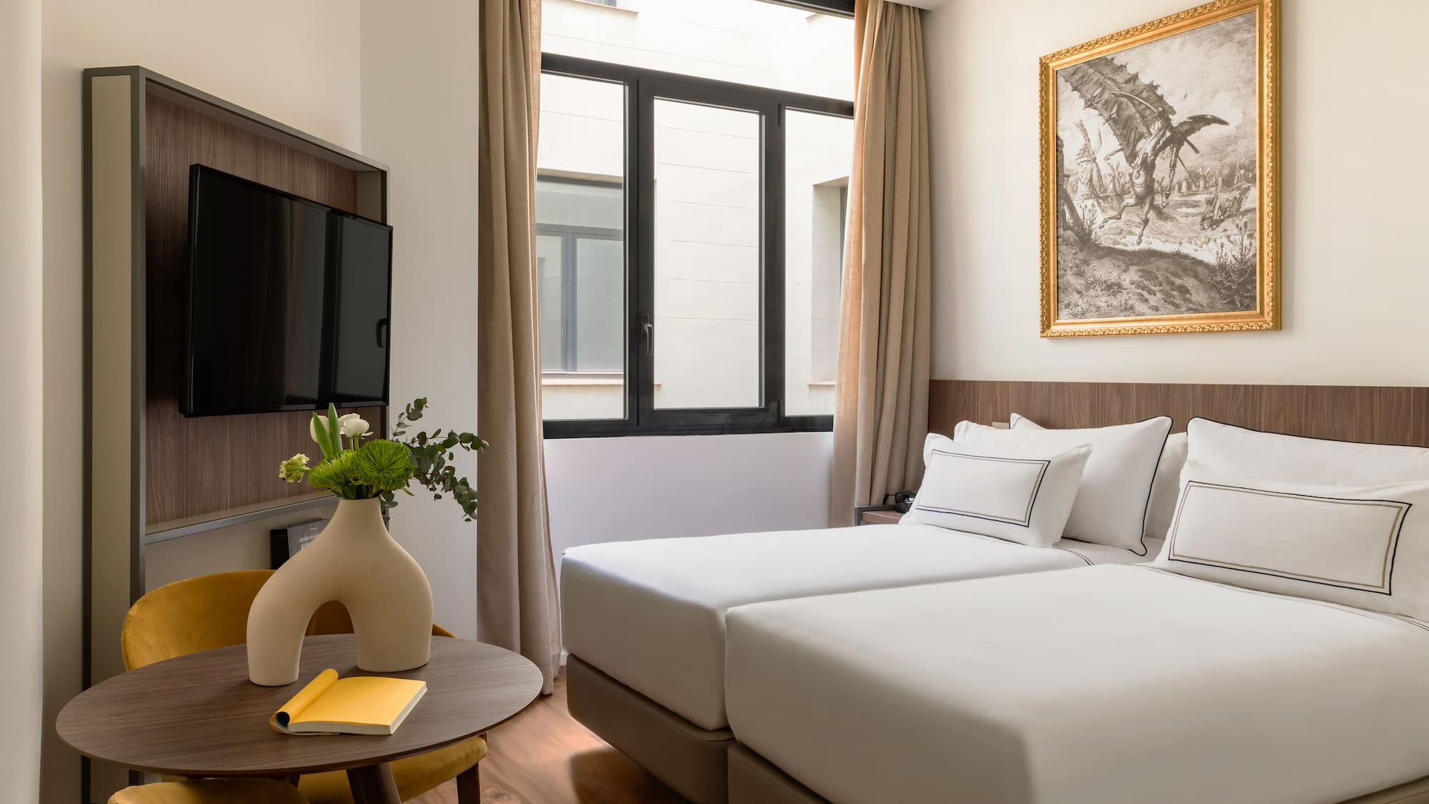 a room with two beds and a tv