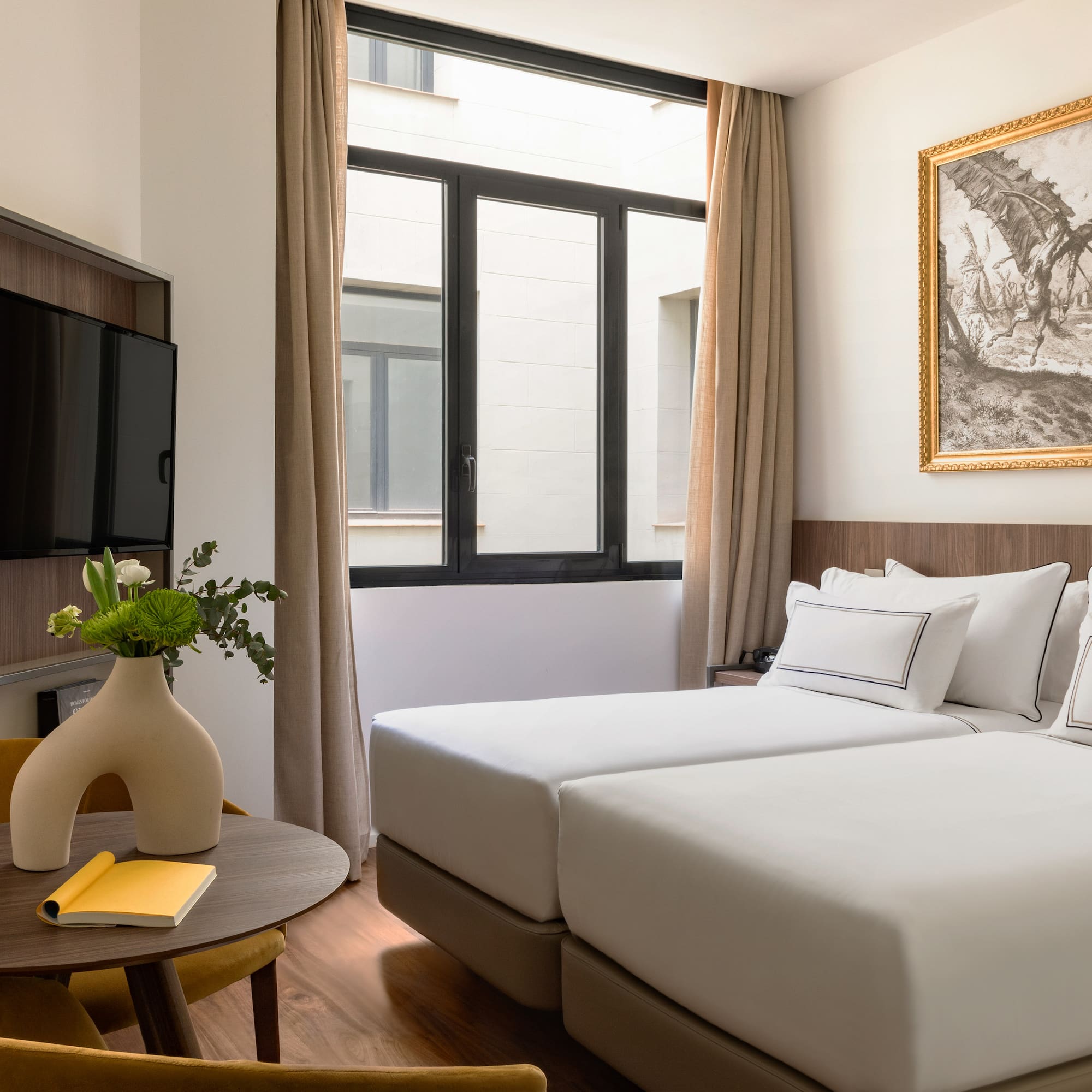 a room with two beds and a tv