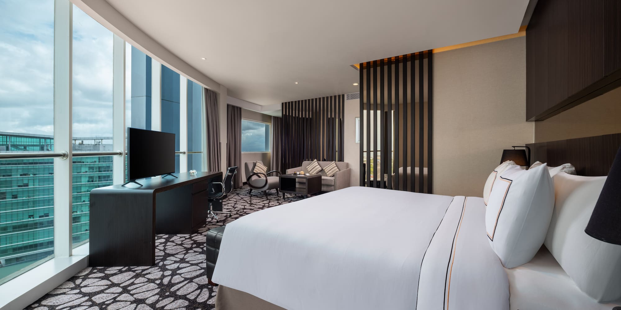 a room with a large bed and a television